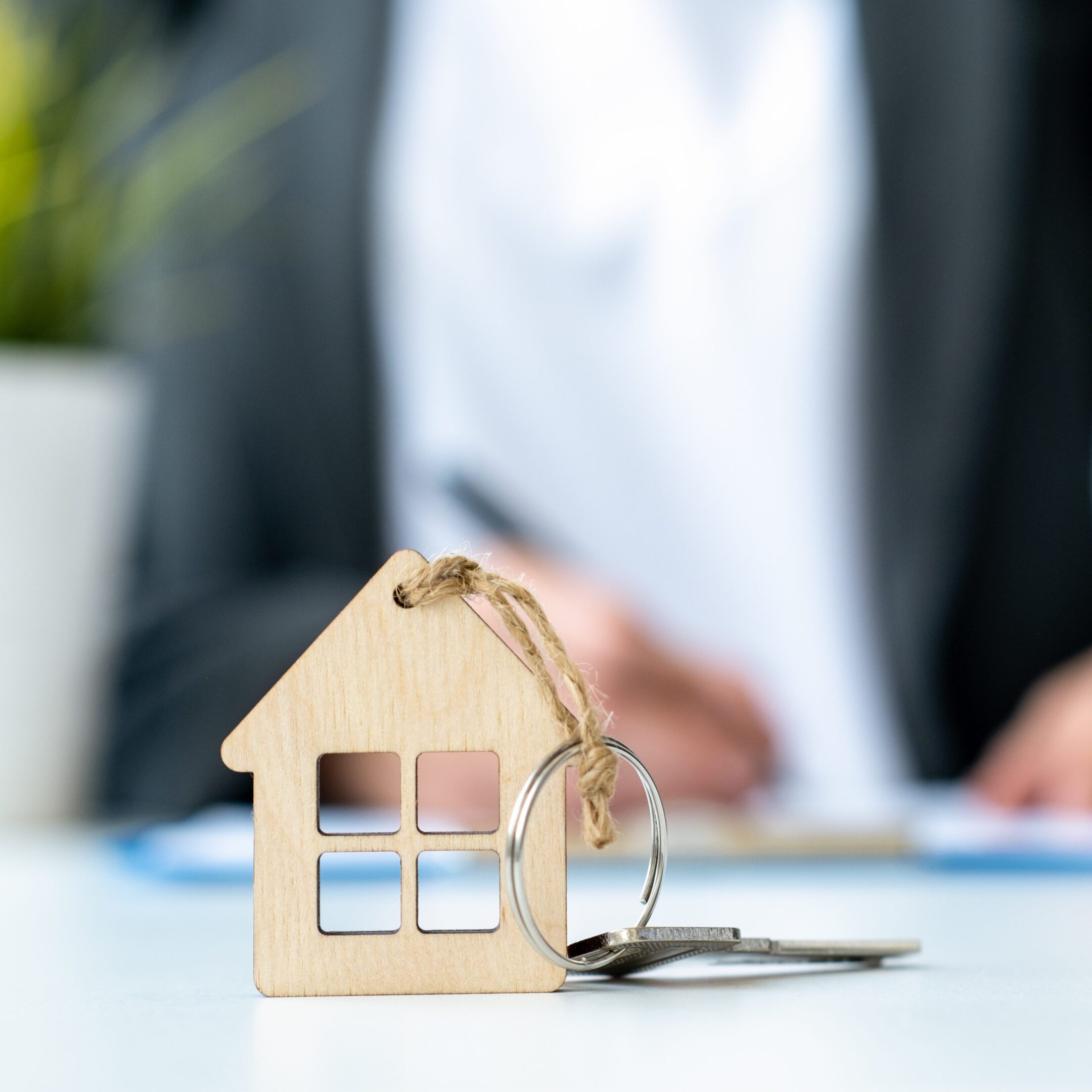 Real estate concept with house-shaped keychain