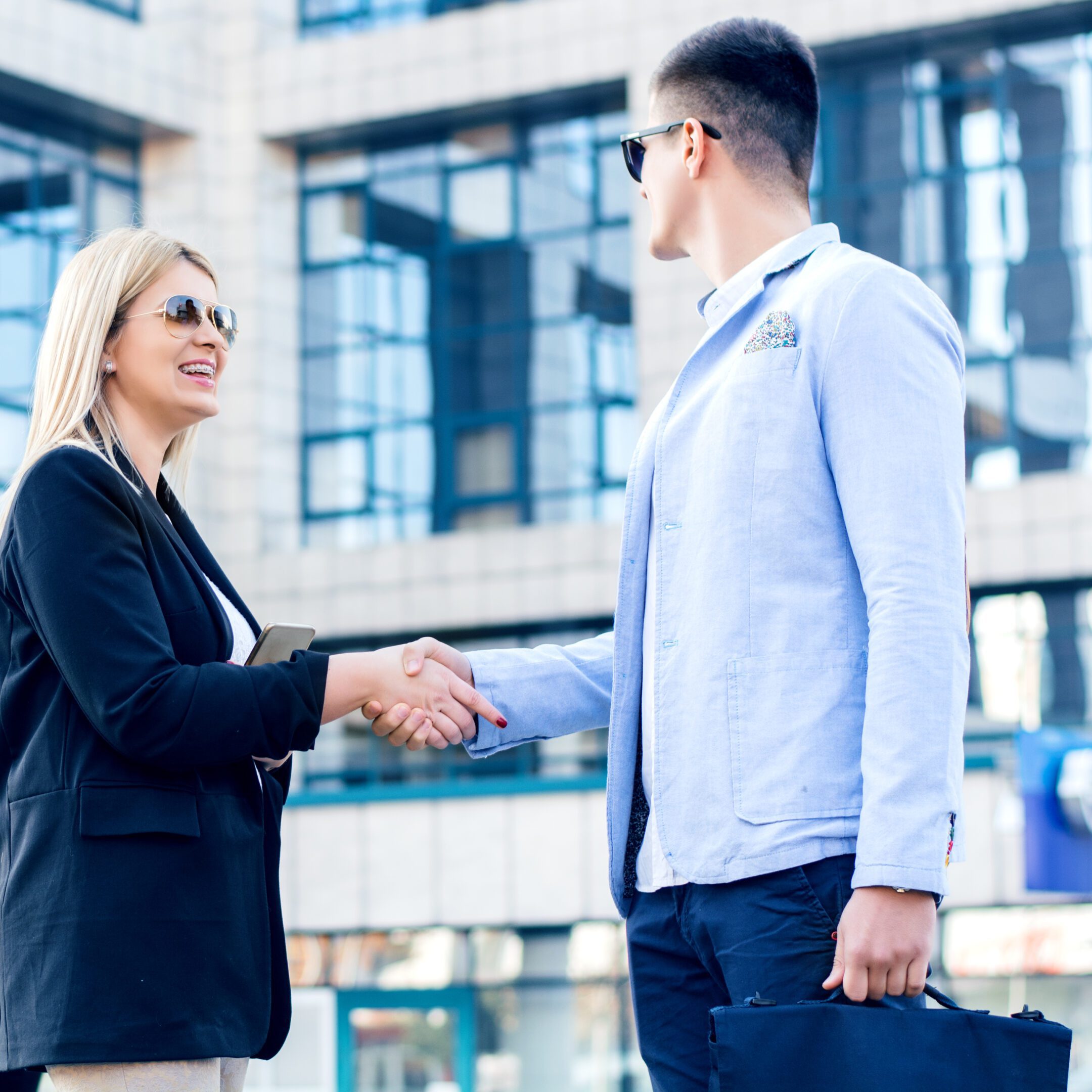 Businesspeople shaking hands outdoors