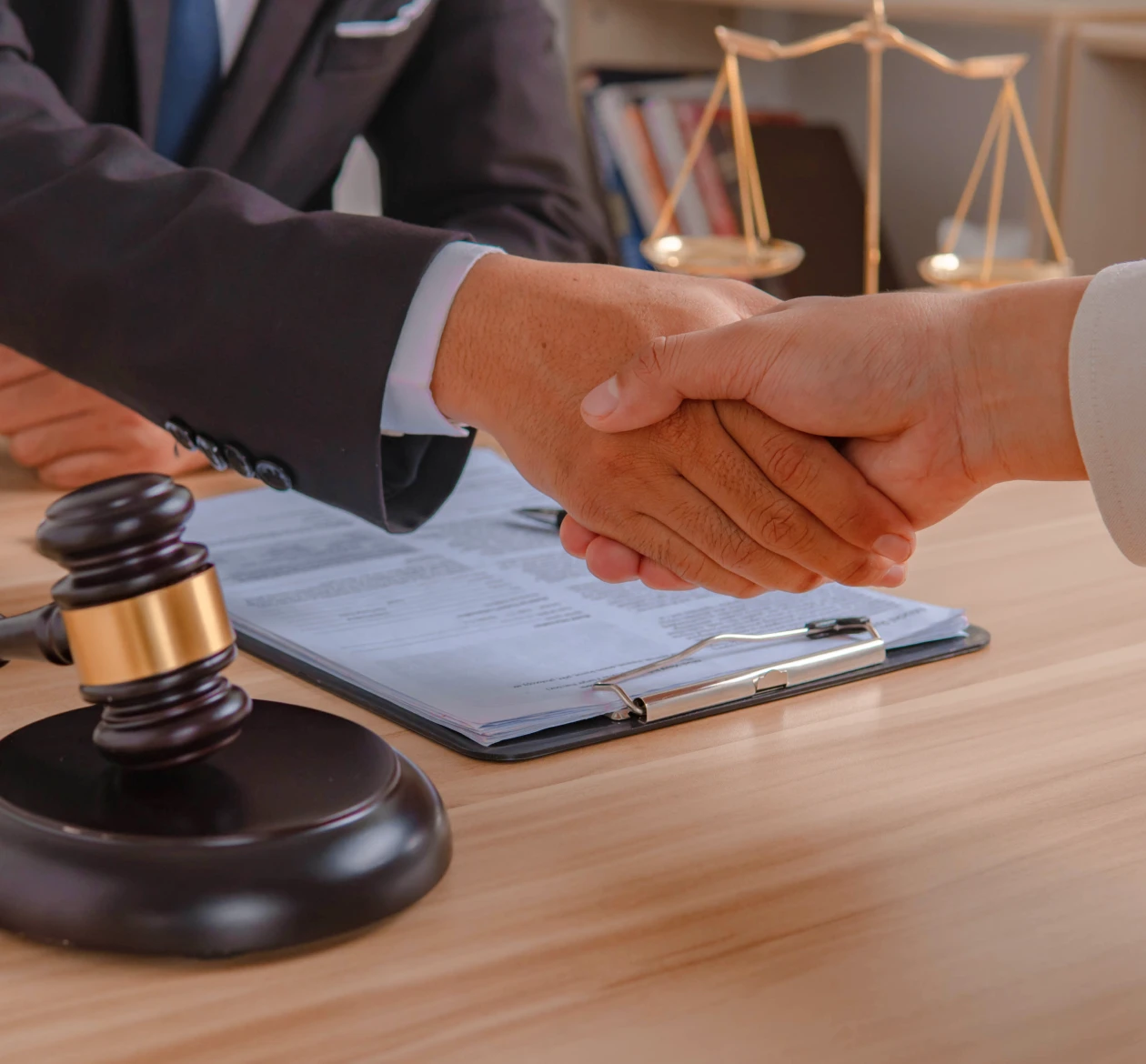 Lawyers shaking hands in office
