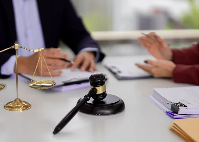 Lawyers discussing case with scale and gavel